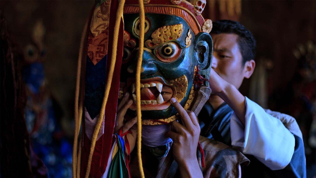 Preparing a mask backstage at Jakar Tshechu